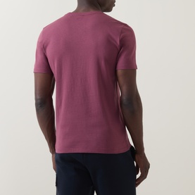 Model wearing Hugo Boss Orange Tales Logo T-Shirt in medium red. Back view showing crew neck, short sleeves and straight hemline.