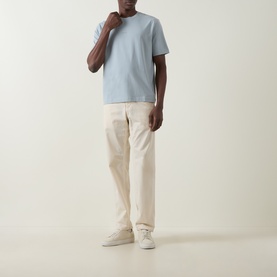 Model wearing Hugo Boss Orange Tchup Tonal Logo T-Shirt in Open Grey with cream chinos and white trainers