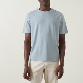 Model wearing Hugo Boss Orange Tchup Tonal Logo T-Shirt in Open Grey, crew neck, short sleeves, styled with cream chinos