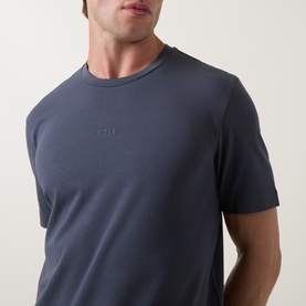 Model wearing Hugo Boss Orange T Chup Logo T-Shirt in dark blue, crew neck with tonal micro logo detail at chest, short sleeves