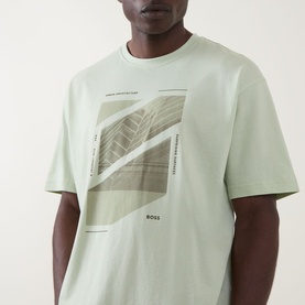 Model wearing Hugo Boss Orange Te Journey Relaxed Fit T-Shirt in Open Green with front graphic print, crew neck, and short sleeves