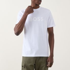 Model wearing Hugo Boss Orange Te Logo T-Shirt in white with tonal BOSS chest logo, styled with khaki cargo trousers.