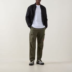 Model wearing Hugo Boss Orange Te Logo T-Shirt in White, styled with black bomber jacket, olive cargo trousers and chunky trainers.