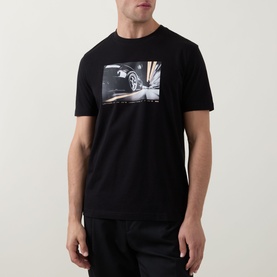 Model wearing Hugo Boss Orange black crew neck cotton T-shirt with large car graphic print on chest.