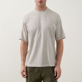 Model wearing Hugo Boss Orange light beige cotton crew neck T-shirt with tonal logo print, styled with khaki trousers