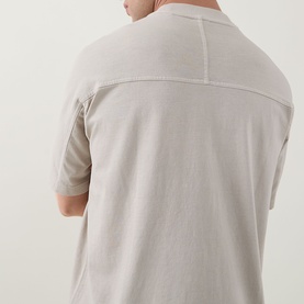 Model wearing Hugo Boss Orange light beige 100% cotton crew neck T-shirt, rear view showing back seam detail and short sleeves.
