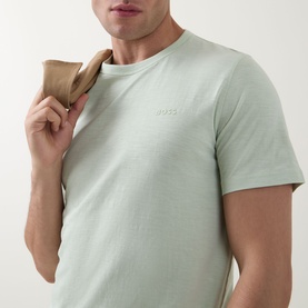 Model wearing Hugo Boss Orange Open Green crew neck T-shirt in cotton, styled with a tan jacket draped over shoulder