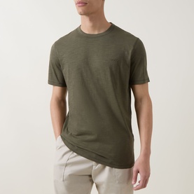 Model wearing Hugo Boss Orange Bright Green cotton crew neck T-shirt with beige trousers