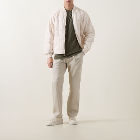 Model wearing Hugo Boss Orange Bright Green crew neck cotton T-shirt, styled with light quilted bomber jacket and stone chinos.