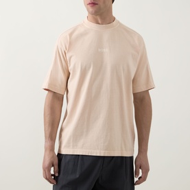 Model wearing Hugo Boss Orange light pastel orange cotton crew neck T-shirt with small chest logo, styled with dark shorts