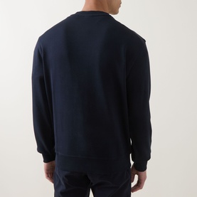 Model wearing Hugo Boss Orange dark blue cotton crew neck sweatshirt, rear view showing ribbed cuffs and hem