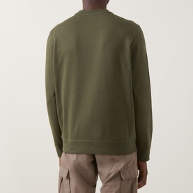 Model wearing Hugo Boss Orange Westart Logo Sweater in Bright Green, crew neck with ribbed trims, back view, styled with beige cargo trousers