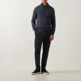 Model wearing Hugo Boss Orange Kanobix Half-Zip Sweater in dark blue, styled with dark trousers and light suede shoes