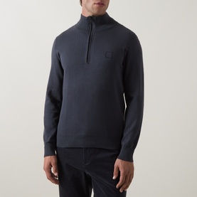 Model wearing Hugo Boss Orange Kanobix Half-Zip Sweater in dark blue, fine-knit cotton-cashmere with logo badge, styled with dark trousers