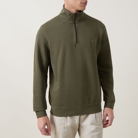 Model wearing Hugo Boss Orange Bright Green cotton half-zip sweatshirt with ribbed cuffs and hem, small logo patch at chest, styled with light