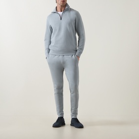 Model wearing Hugo Boss Orange Zetrust Half-Zip Sweatshirt in Open Grey, styled with matching grey joggers and navy trainers.
