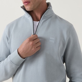 Model wearing Hugo Boss Orange Zetrust Half-Zip Sweatshirt in Open Grey, showing funnel neck, half-zip fastening and chest logo badge.