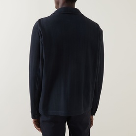 Model wearing Hugo Boss Carper Stripe Overshirt in dark blue, rear view showing flat collar, long sleeves, and straight hemline
