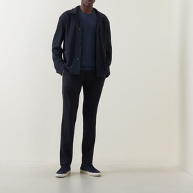 Model wearing Hugo Boss Carper Stripe Overshirt in dark blue with navy trousers and white low-top trainers.