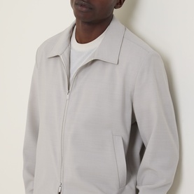 Model wearing Hugo Boss light beige wool jacket with zip fastening and shirt collar, styled with white crew-neck tee