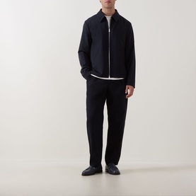 Model wearing Hugo Boss dark blue wool zip-through jacket with white T-shirt and matching dark blue tailored trousers.