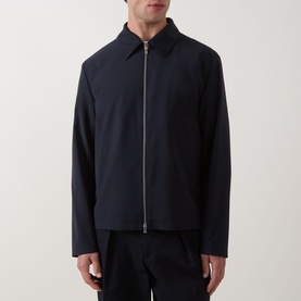 Model wearing Hugo Boss dark blue wool zip-through jacket with shirt collar, styled with black trousers.