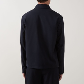 Model wearing Hugo Boss dark blue wool-blend jacket, rear view, styled with matching dark blue trousers.