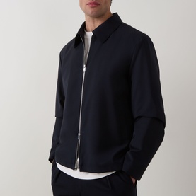 Model wearing Hugo Boss dark blue wool zip-up jacket with shirt collar, styled with white T-shirt and navy trousers