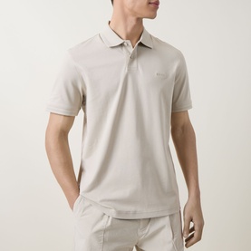 Model wearing Hugo Boss Orange light beige cotton polo shirt with classic collar and short sleeves, styled with beige trousers