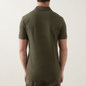 Model wearing Hugo Boss Orange polo in Bright Green, rear view, short sleeves, ribbed collar, slim fit cotton piqu&eacute;