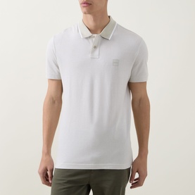 Model wearing Hugo Boss Orange Passerford Tipped Logo Polo Shirt in light beige with tipped collar, short sleeves and tonal logo badge
