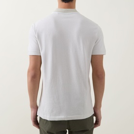 Model wearing Hugo Boss Orange Passerford Tipped Logo Polo Shirt in Light Beige, back view, paired with khaki trousers.