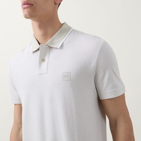 Model wearing Hugo Boss Orange Passerford Tipped Logo Polo Shirt in Light Beige with contrast-tipped collar and tonal logo badge