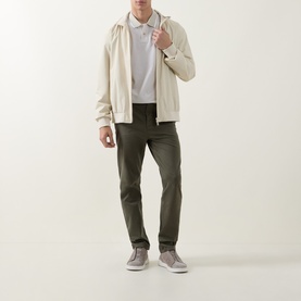 Model wearing Hugo Boss Orange Passerford Tipped Logo Polo Shirt in Light Beige, styled with cream zip-up hoodie and khaki trousers