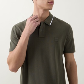 Model wearing Hugo Boss Orange Passerford Tipped Logo Polo Shirt in Bright Green with white tipped collar and tonal logo badge at chest