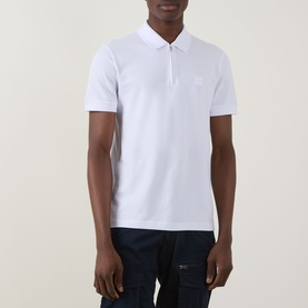 Model wearing Hugo Boss Orange Passertip Logo Polo Shirt in white with half-zip placket and tonal logo, styled with dark cargo trousers