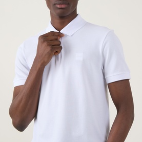 Model wearing Hugo Boss Orange Passertip Logo Polo Shirt in white, showing half-zip placket, polo collar and tonal chest logo detail.