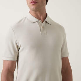Model wearing Hugo Boss Orange light beige cotton polo shirt with ribbed collar and two-button placket, short sleeves