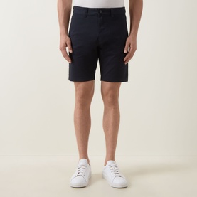 Model wearing Hugo Boss Orange dark blue cotton chino shorts, styled with white low-top trainers