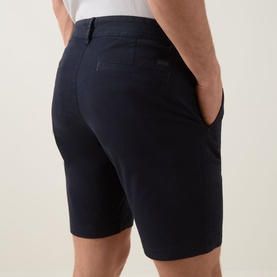 Model wearing Hugo Boss Orange dark blue cotton chino shorts, rear view showing back pockets and slim tailored fit.