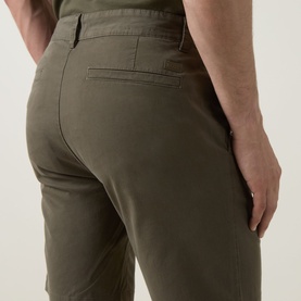 Model wearing Hugo Boss Orange bright green cotton stretch shorts, close-up of rear pocket and waistband detail