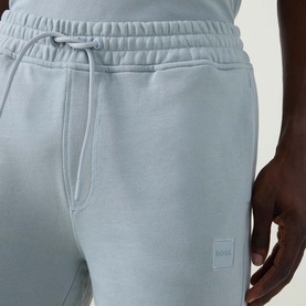 Model wearing Hugo Boss Orange Open Grey cotton shorts, featuring drawstring waist, side pockets and tonal logo patch.