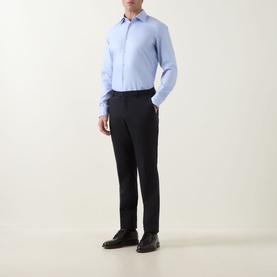 Model wearing Hugo Boss Light Blue Cotton Single Cuff Slim formal shirt with dark navy trousers and black leather shoes.