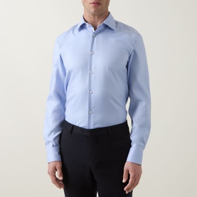 Model wearing Hugo Boss light blue slim fit single cuff cotton formal shirt, styled with black trousers