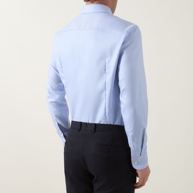 Model wearing Hugo Boss light blue slim fit cotton formal shirt, back view, styled with dark trousers. Single cuff detail visible.