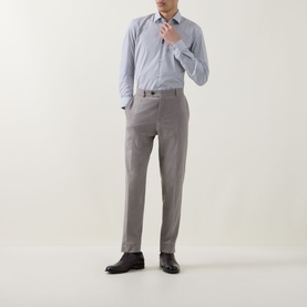 Model wearing Hugo Boss Dark Blue Single Cuff Slim shirt, styled with grey tailored trousers and dark brown leather shoes.