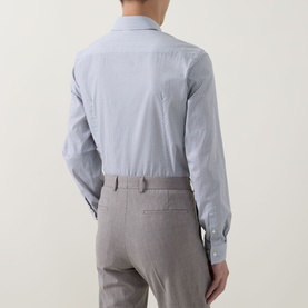 Model wearing Hugo Boss Dark Blue Single Cuff Slim formal shirt, rear view, styled with light grey tailored trousers