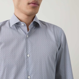 Model wearing Hugo Boss dark blue slim fit formal shirt with small all-over print, spread collar and single cuff detail visible