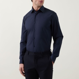 Model wearing Hugo Boss dark blue single cuff regular fit formal shirt, styled with matching dark navy trousers.