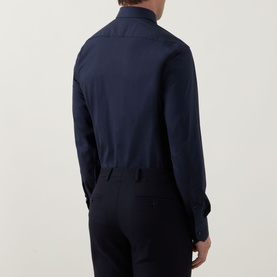 Model wearing Hugo Boss dark blue single cuff regular fit formal shirt, rear view, paired with navy trousers